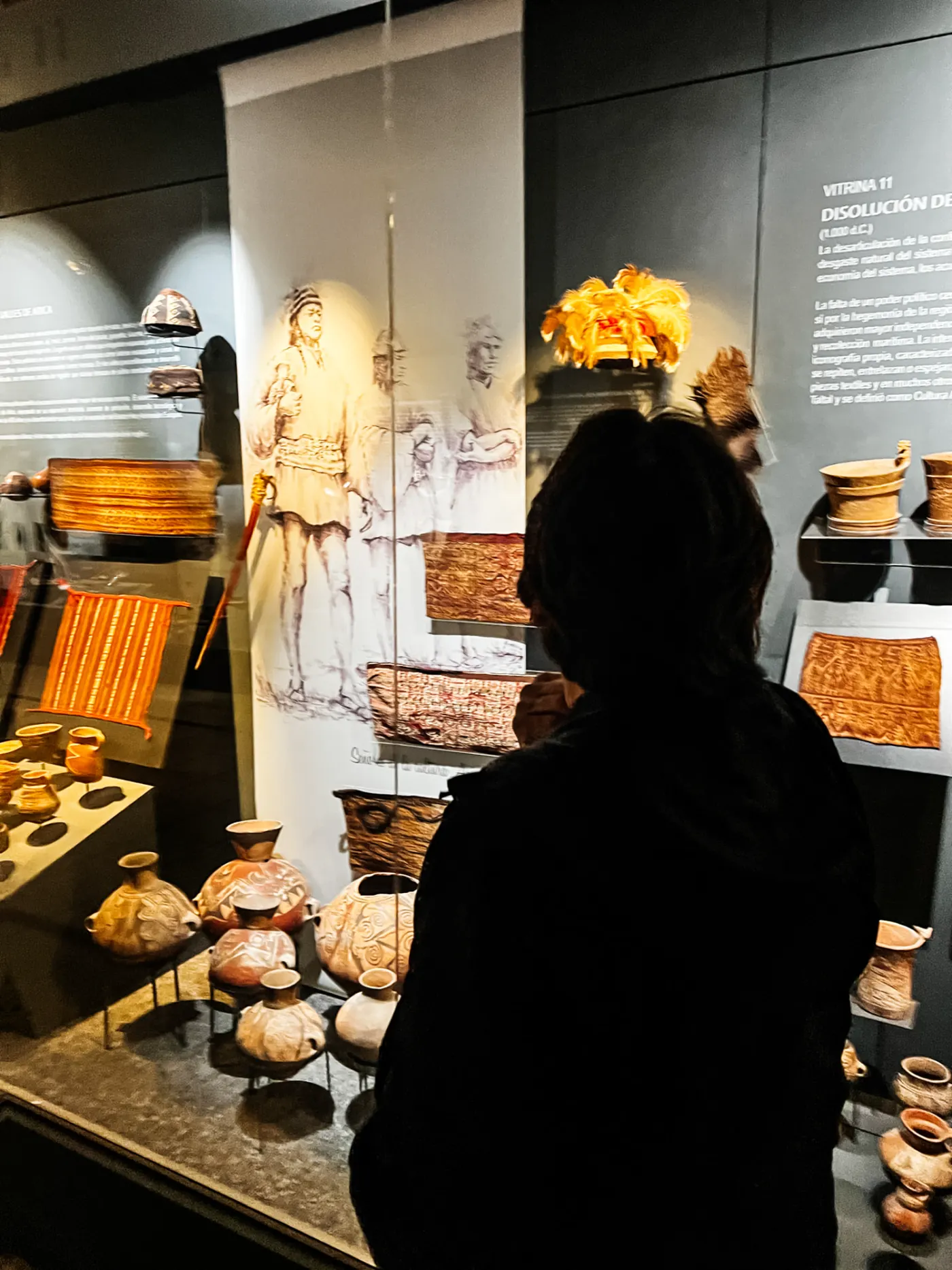 Visitante observando peças arqueológicas no Museu San Miguel de Azapa