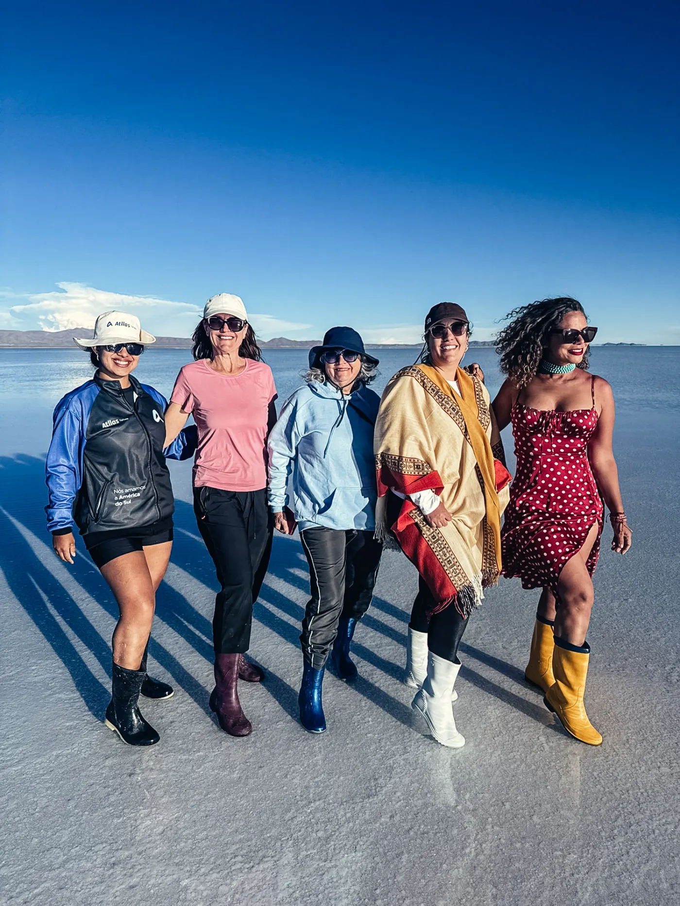 Grupo Atllas caminhando no espelho d'água do Salar de Uyuni